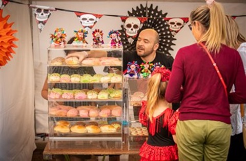 Customers buying sweets at local event