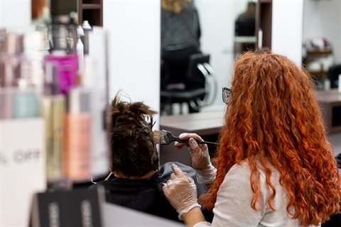 Haridresser colouring clients hair